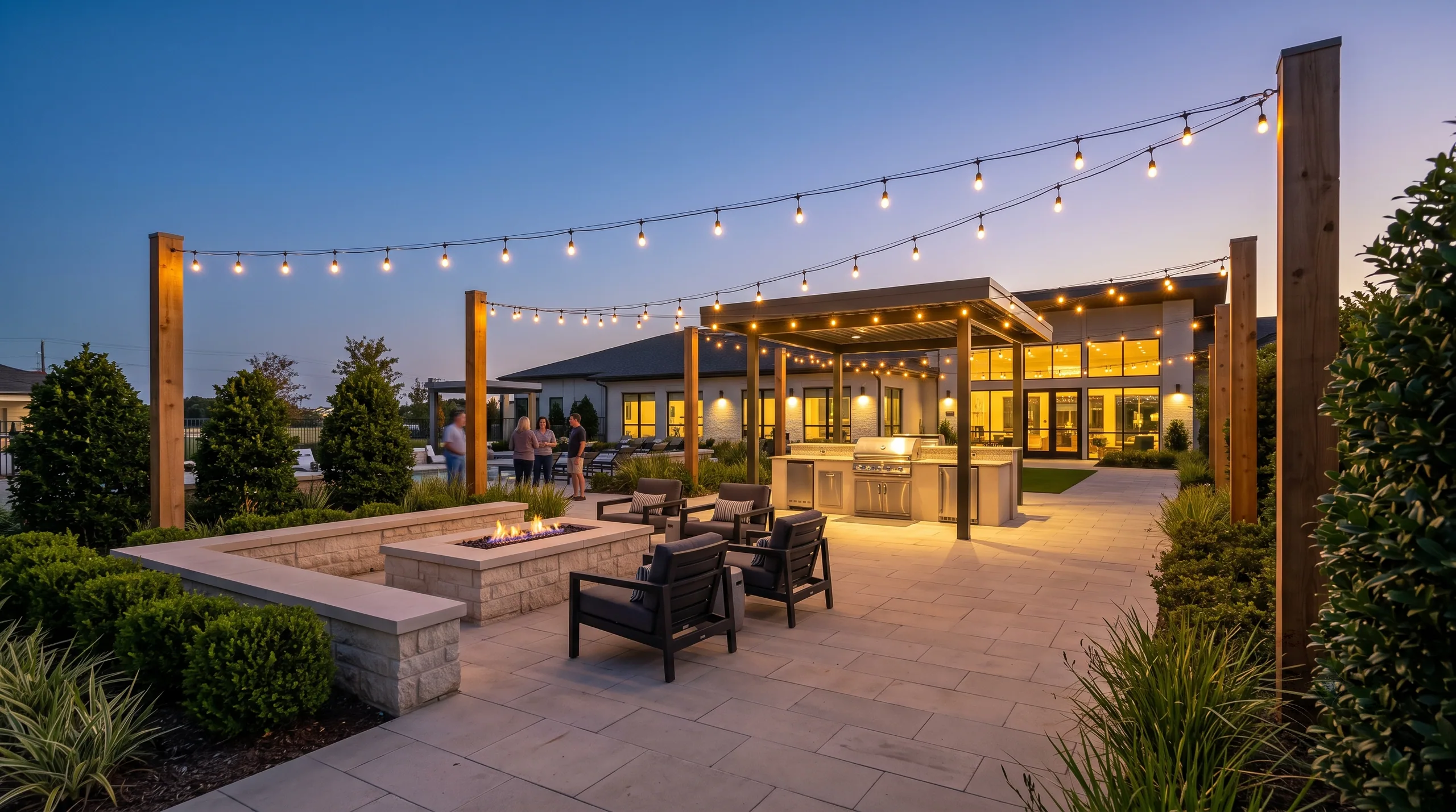 A clubhouse terrace of café tables under string lights, with residents seated at mid-distance, faces indistinct.